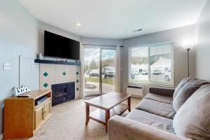 a living room with a couch and a fireplace at Harbor Village Pool Building Condo 104 in Garden City