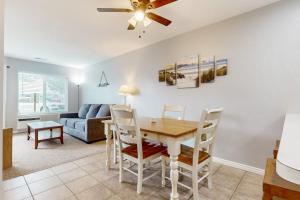 a living room with a dining room table and a couch at Harbor Village Pool Building Condo 104 in Garden City