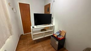 a flat screen tv sitting on a white entertainment center at Pousada Beach House Coqueirinho in Jacumã