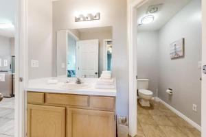 a bathroom with a sink and a toilet at Harbor Village Pool Building Condo 104 in Garden City