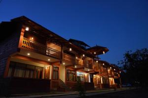 a large building with lights on it at night at HighFields Coorg in Virajpet