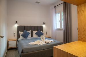 a bedroom with a bed with a towel on it at Villa Voka in Acharavi +52 photos