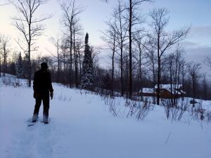 a man is standing on skis in the snow at Timber Baron Inn in Bayfield