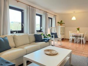 a living room with a couch and a table at Finnhaus Fiete in Marlow