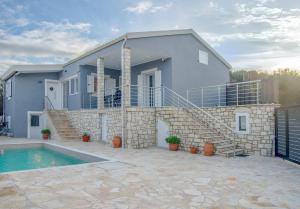 a house with a swimming pool in front of it at Villa Voka in Acharavi