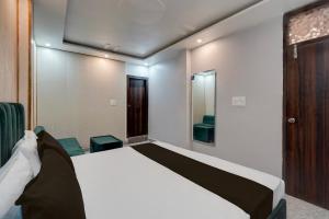 a bedroom with a large bed and a television at HOTEL O BLUE DIAMOND in Prayagraj