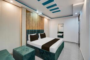 a bedroom with a bed and two stools in it at HOTEL O BLUE DIAMOND in Prayagraj