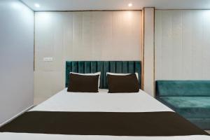 a bedroom with a large bed with two pillows at HOTEL O BLUE DIAMOND in Prayagraj