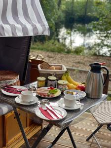 a table with food and a tea pot on it at 39 Mini Pod "Treene" in Silberstedt