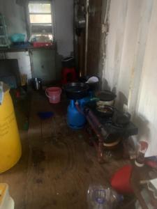 a dirty room with a stove and a sink at Good home in Codrington Village