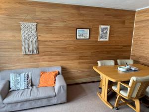 a living room with a couch and a table at The Lodge In Sapporo in Sapporo