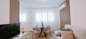 a living room with a table and a tv at Happy Dreams Apartment near the beach and old town in Split