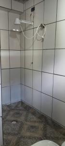 a bathroom with a shower and a toilet at Hospedagem Maranata in Santo André