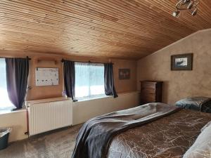 a bedroom with a bed and a wooden ceiling at Northern Sky Lodge in Fairbanks