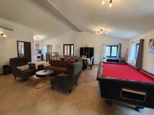 a living room with a pool table in it at Villa Tramonto 4 stars, Krnica in Krnica