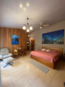 a bedroom with a bed and a chair and a table at Cala Lodge in Monteverde Costa Rica