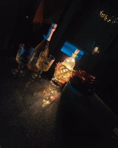 a group of three wine glasses and a bottle at Ferienhaus-Sauna Pool Whirlpool in Grimma