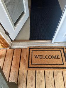 a welcome mat on the floor in front of a door at Modern studio Cabin in Tok