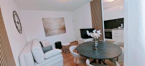 a living room with a table and a couch at Happy Dreams Apartment near the beach and old town in Split