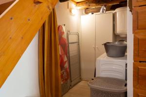 a bathroom with a washer and dryer in a tiny house at Eligia home in Angouselianá +21 photos