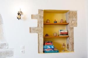 a shelf in a wall with books on it at Eligia home in Angouselianá