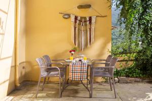 a table with chairs and a table cloth on it at Eligia home in Angouselianá