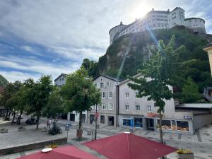 a building with a castle on top of a mountain at Hotel Goldener Löwe in Kufstein