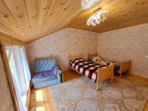 a room with a couch and a chair in a room at Xinaliq Khinalig İzzet's Riverside Home Stay in Xınalıq +143 photos
