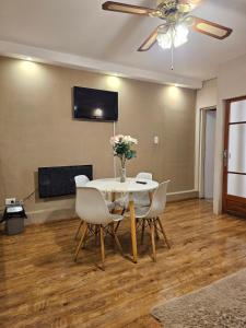a dining room with a table and chairs and a ceiling fan at APART ALVARADO microcentro in Salta