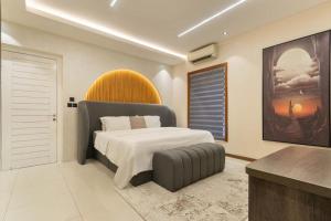 a bedroom with a large bed and a table at Bridge Apartment Lagos in Lekki +9 photos