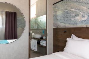 a bedroom with a mirror and a bed and a sink at Calle Suite Lazise in Lazise +46 photos