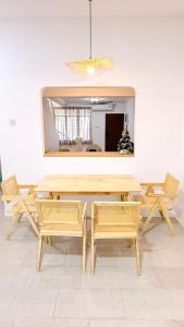 a table and chairs in a room with a mirror at Leisure29 Suites - Setali - 7pax in Kuantan