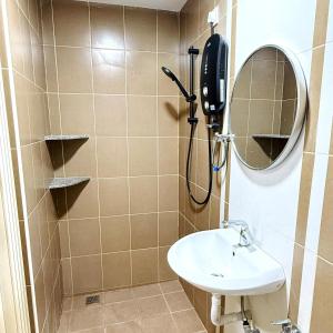 a bathroom with a shower with a sink and a mirror at Leisure29 Suites - Setali - 7pax in Kuantan +12 photos