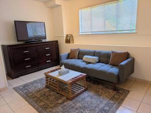 a living room with a couch and a flat screen tv at Ashwood monthly in Courtenay