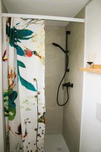 a shower in a bathroom with a shower curtain at #studio 19 in Saint-Léonard