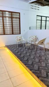 two chairs and a table in a room at Leisure29 Suites - Setali - 7pax in Kuantan
