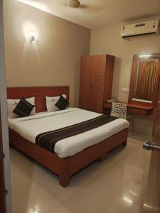 a bedroom with a large bed in a room at skylink residency in Chennai +52 photos