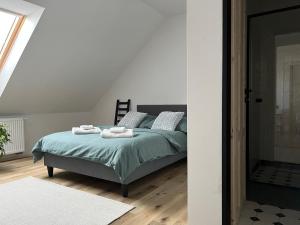 a bedroom with a bed with two towels on it at Penzion Lívanec in Horní Bezděkov