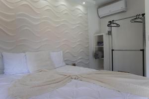 a bedroom with a large white bed with white pillows at La Ceiba Suite 2 with private plunge pool in Anasco +8 photos