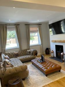 a living room with a couch and a table at Willow Lodge in Kilham