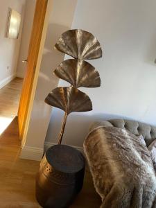 a plant lamp in a living room next to a couch at Willow Lodge in Kilham +6 photos