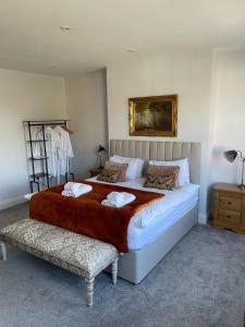 a bedroom with a large bed with two pillows at Willow Lodge in Kilham