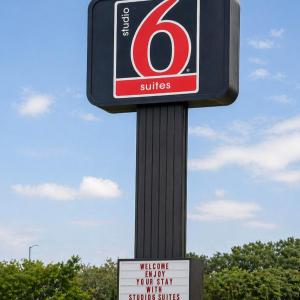 a gas station sign on a pole with two signs at Studio 6 Suites Mesquite, TX – Gross Rd. in Mesquite