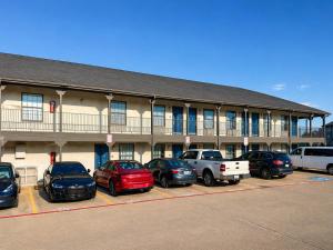 a building with cars parked in a parking lot at Studio 6 Suites Mesquite, TX – Gross Rd. in Mesquite
