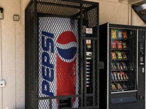 a soda machine with a pepsi sign on it at Studio 6 Suites Mesquite, TX – Gross Rd. in Mesquite +19 photos