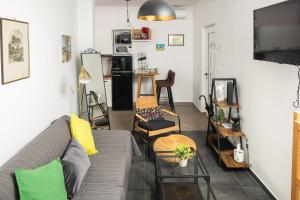 a living room with a gray couch and chairs at Jakov & Antonia Heritage Estate in Hvar