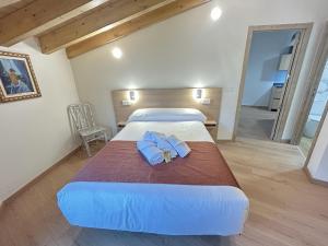 a bedroom with a large bed with blue towels on it at Apartamentos Los 5 Sentidos in Grado