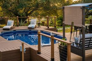 a swimming pool on a wooden deck next to at Serene Mountain Retreat With Pool in Clermont