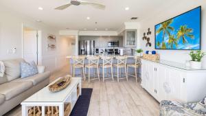 a living room with a couch and a table at Sunrise Oasis - Top Floor Ocean Pointe 2411 in Key Largo