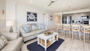 a living room with a couch and a table at Sunrise Oasis - Top Floor Ocean Pointe 2411 in Key Largo +61 photos